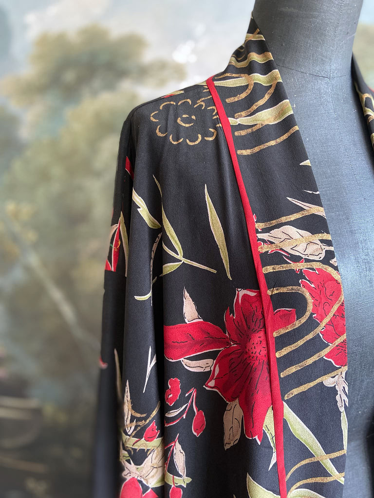 Full length 1920s inspired kimono robe with large patch pockets. Newly created from a scarlet and black 1930s style splashy floral vintage silk crepe. Fully lined in silk with French seams throughout. Bohemian styles sustainably created from antique and vintage textiles by the Pavilion Parade studio.
