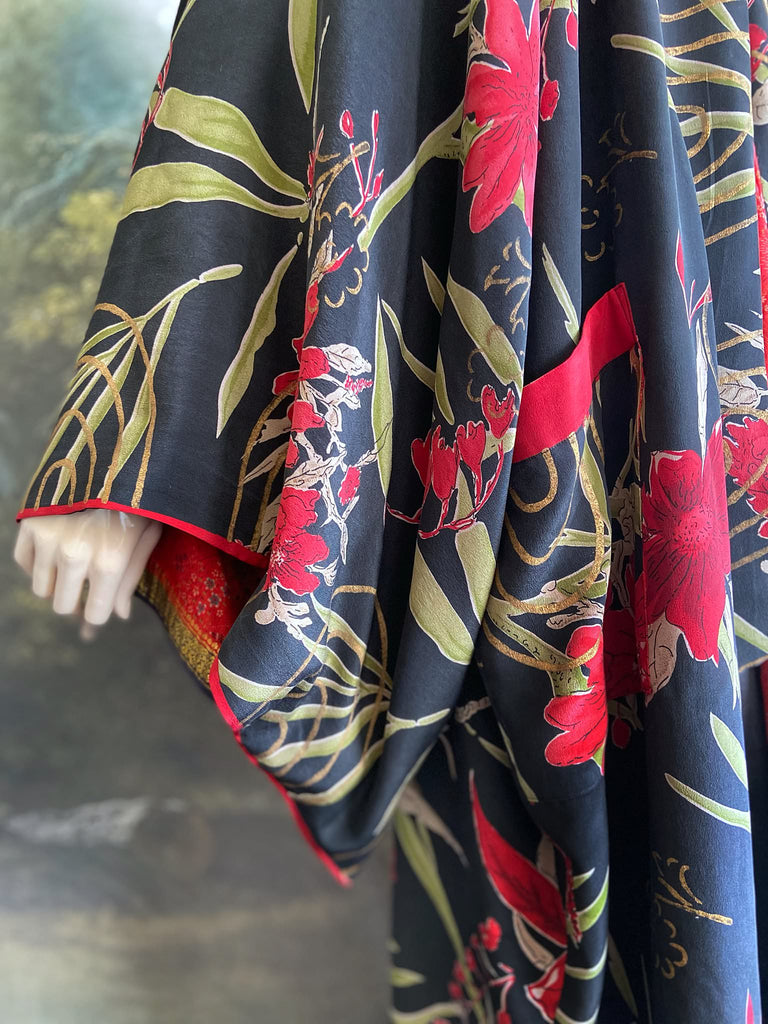 Full length 1920s inspired kimono robe with large patch pockets. Newly created from a scarlet and black 1930s style splashy floral vintage silk crepe. Fully lined in silk with French seams throughout. Bohemian styles sustainably created from antique and vintage textiles by the Pavilion Parade studio.