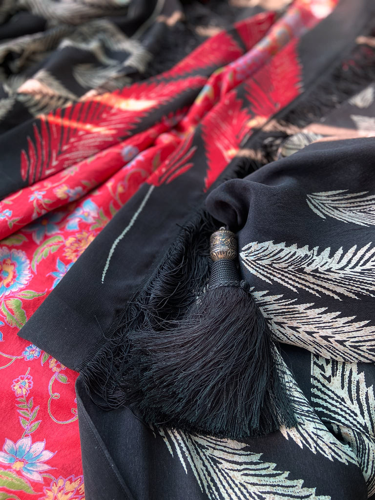 Full length 1920s inspired kimono robe with large patch pockets. Newly created from a crimson red and kohl black block print feather vintage crepe. Antique silk fringe on collar and large weighted tassels on sleeves. Fully lined in silk with French seams throughout. Bohemian styles sustainably created from antique and vintage textiles by the Pavilion Parade studio.