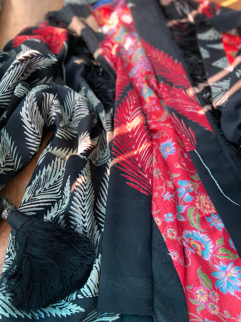 Full length 1920s inspired kimono robe with large patch pockets. Newly created from a crimson red and kohl black block print feather vintage crepe. Antique silk fringe on collar and large weighted tassels on sleeves. Fully lined in silk with French seams throughout. Bohemian styles sustainably created from antique and vintage textiles by the Pavilion Parade studio.