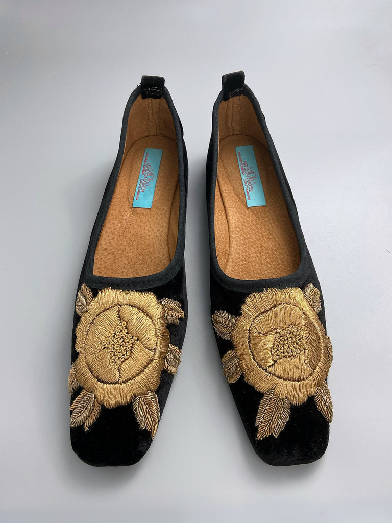 Black silk velvet slipper shoes with extended squared toe shape. Embellished with gold work embroidered roses. Bohemian styles created from antique and vintage textiles by the Pavilion Parade studio. 