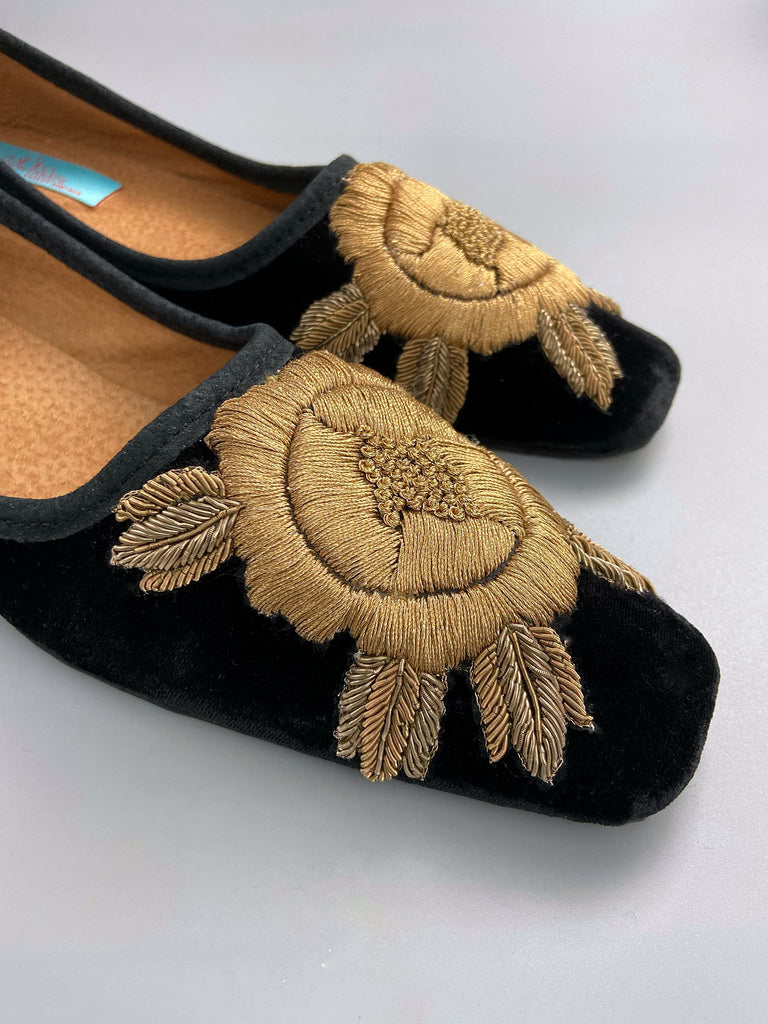 Black silk velvet slipper shoes with extended squared toe shape. Embellished with gold work embroidered roses. Bohemian styles created from antique and vintage textiles by the Pavilion Parade studio. 