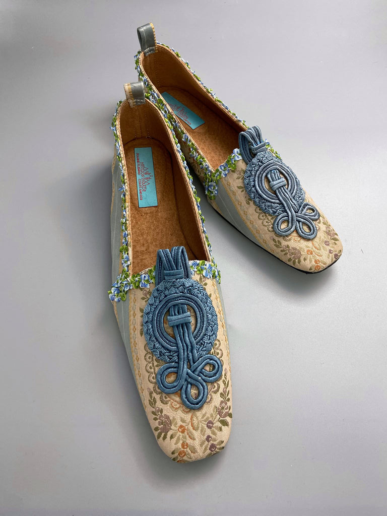 Pale blue and ivory silk brocade Regency inspired dancing slippers with rococo ribbon trim. Embellished with dusty blue antique soutache cord medallions. Bohemian styles created from antique textiles by the Pavilion Parade studio. 