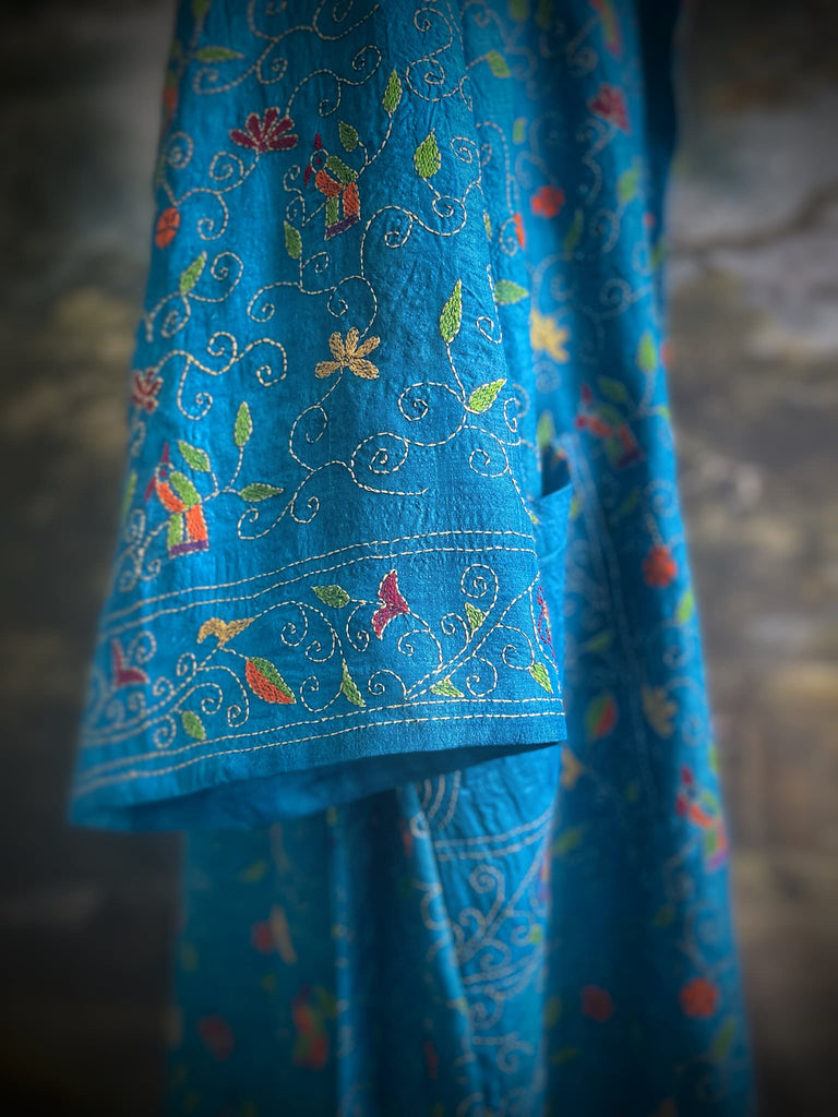 Hand embroidered kantha Royal blue pure silk robe with wide sleeves, tassel sash and patch pockets. Bohemian style created from vintage and antique textiles by Pavilion Parade