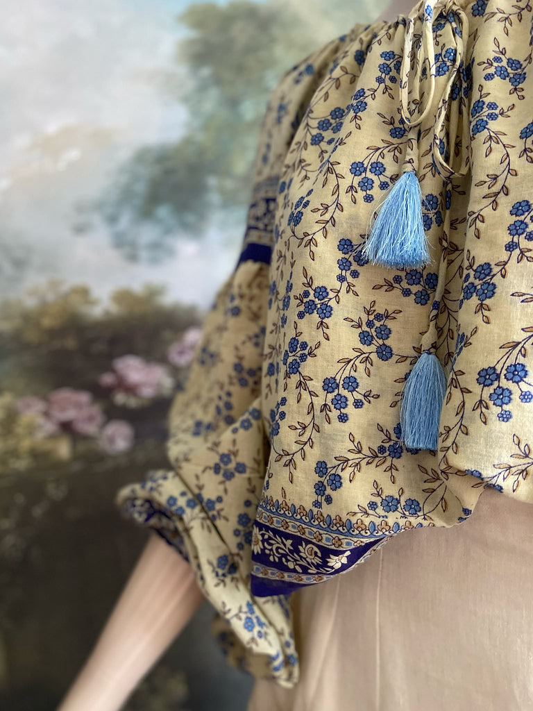 Sky blue and ivory cotton muslin block printed blouse with long full sleeves and adjustable drawstring neckline. Bohemian styles sustainably created from antique and vintage textiles by the Pavilion Parade studio. 