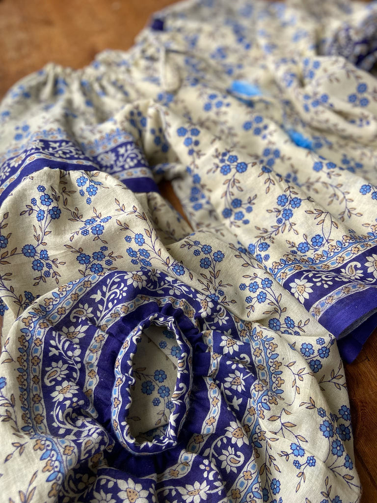 Sky blue and ivory cotton muslin block printed blouse with long full sleeves and adjustable drawstring neckline. Bohemian styles sustainably created from antique and vintage textiles by the Pavilion Parade studio. 