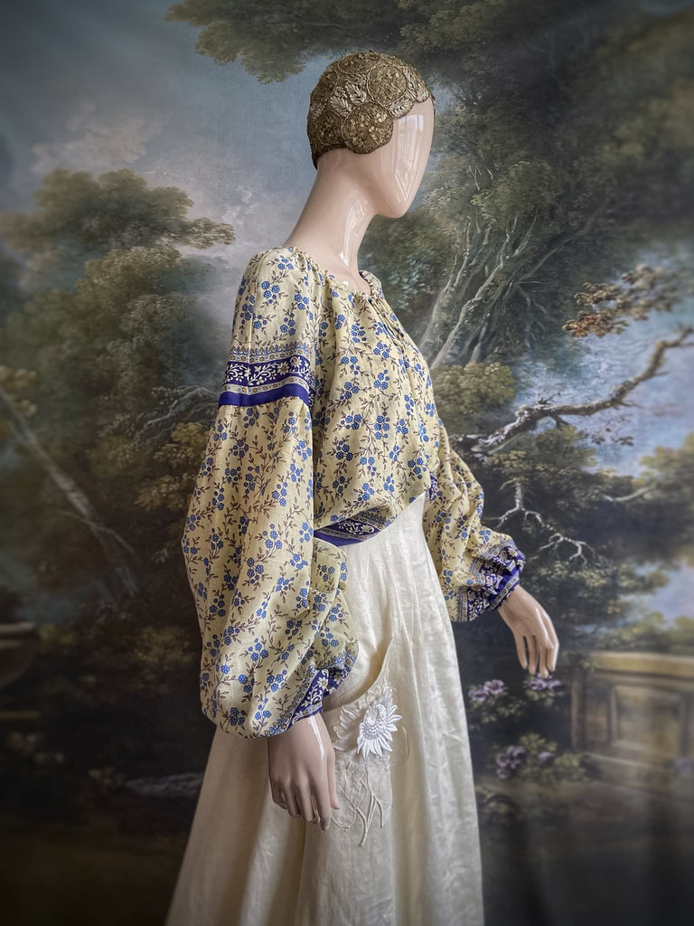 Sky blue and ivory cotton muslin block printed blouse with long full sleeves and adjustable drawstring neckline. Bohemian styles sustainably created from antique and vintage textiles by the Pavilion Parade studio. 