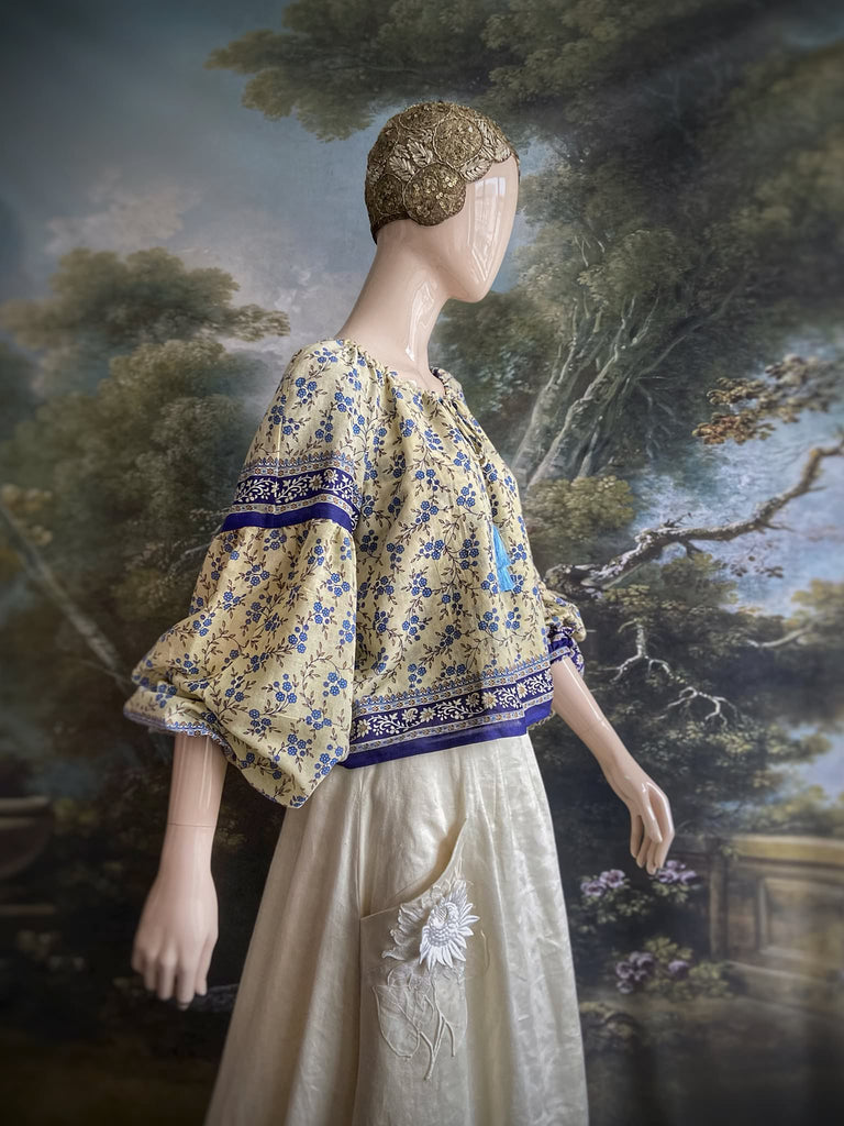 Sky blue and ivory cotton muslin block printed blouse with long full sleeves and adjustable drawstring neckline. Bohemian styles sustainably created from antique and vintage textiles by the Pavilion Parade studio. 