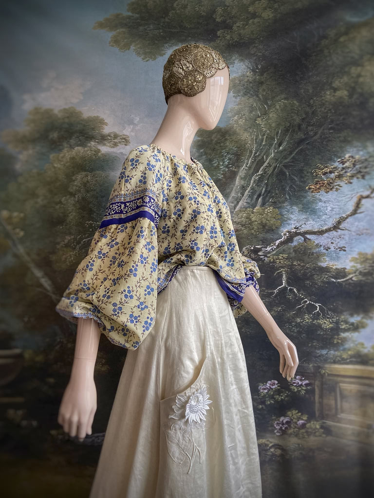 Sky blue and ivory cotton muslin block printed blouse with long full sleeves and adjustable drawstring neckline. Bohemian styles sustainably created from antique and vintage textiles by the Pavilion Parade studio. 