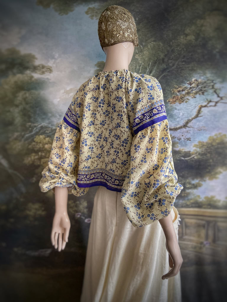 Sky blue and ivory cotton muslin block printed blouse with long full sleeves and adjustable drawstring neckline. Bohemian styles sustainably created from antique and vintage textiles by the Pavilion Parade studio. 