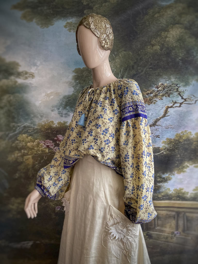 Sky blue and ivory cotton muslin block printed blouse with long full sleeves and adjustable drawstring neckline. Bohemian styles sustainably created from antique and vintage textiles by the Pavilion Parade studio. 