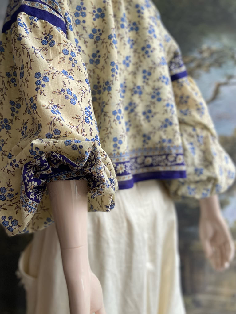 Sky blue and ivory cotton muslin block printed blouse with long full sleeves and adjustable drawstring neckline. Bohemian styles sustainably created from antique and vintage textiles by the Pavilion Parade studio. 