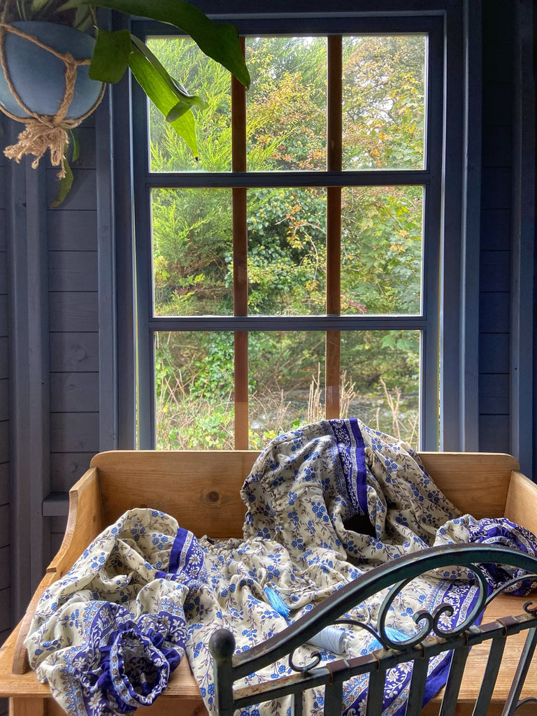 Sky blue and ivory cotton muslin block printed blouse with long full sleeves and adjustable drawstring neckline. Bohemian styles sustainably created from antique and vintage textiles by the Pavilion Parade studio. 