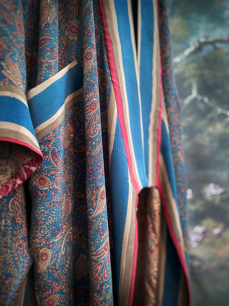 Full length 1920s inspired kimono robe with large patch pockets. Newly created from a blue, red and pumpkin vintage silk crepe. Fully lined in silk with French seams throughout. Bohemian styles sustainably created from antique and vintage textiles by the Pavilion Parade studio.