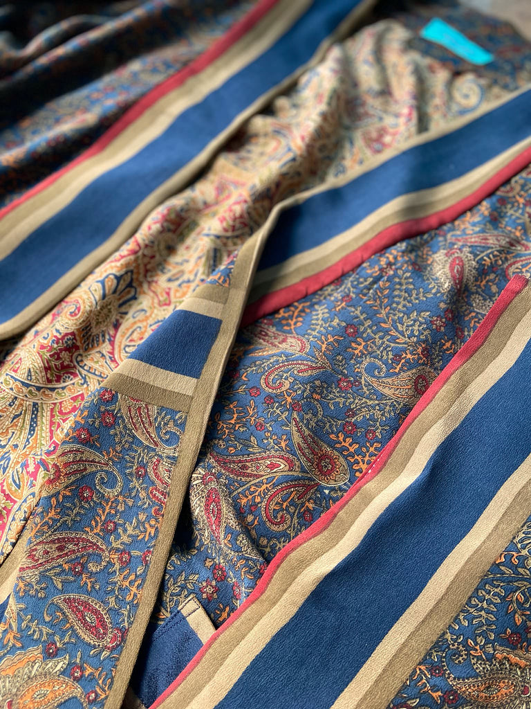 Full length 1920s inspired kimono robe with large patch pockets. Newly created from a blue, red and pumpkin vintage silk crepe. Fully lined in silk with French seams throughout. Bohemian styles sustainably created from antique and vintage textiles by the Pavilion Parade studio.