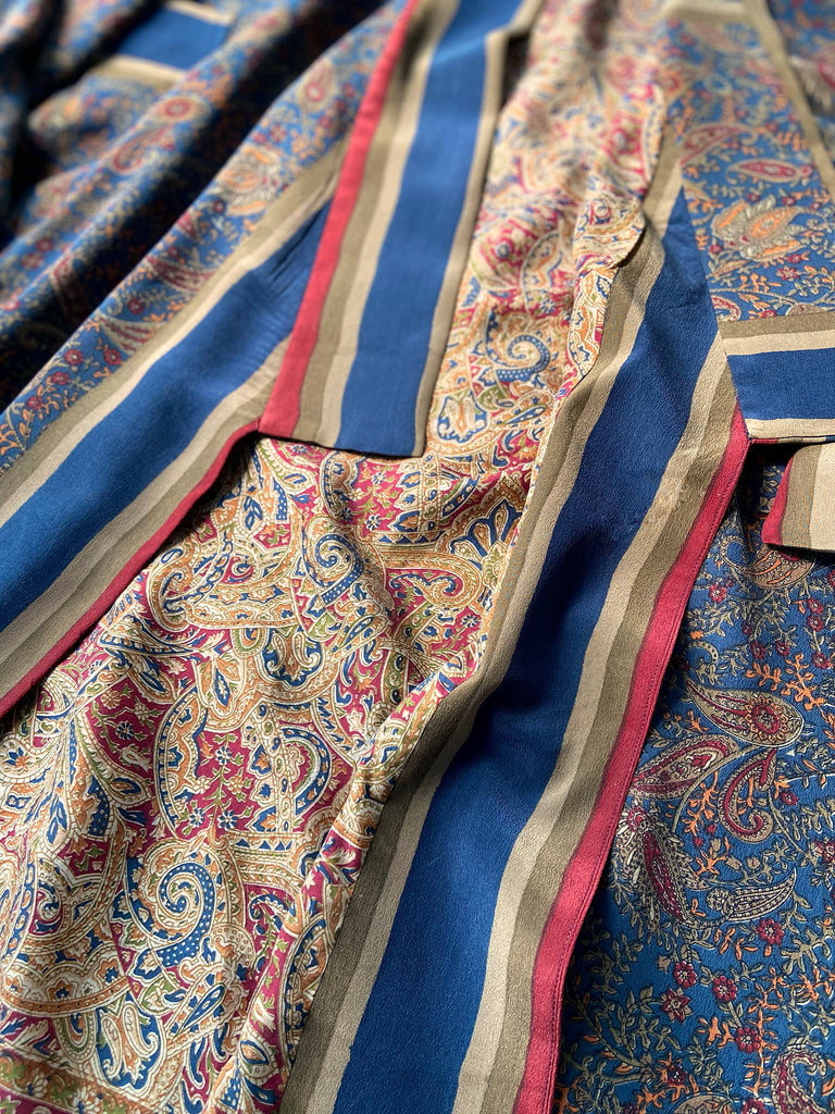Full length 1920s inspired kimono robe with large patch pockets. Newly created from a blue, red and pumpkin vintage silk crepe. Fully lined in silk with French seams throughout. Bohemian styles sustainably created from antique and vintage textiles by the Pavilion Parade studio.