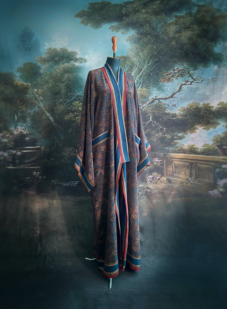 Full length 1920s inspired kimono robe with large patch pockets. Newly created from a blue, red and pumpkin vintage silk crepe. Fully lined in silk with French seams throughout. Bohemian styles sustainably created from antique and vintage textiles by the Pavilion Parade studio.
