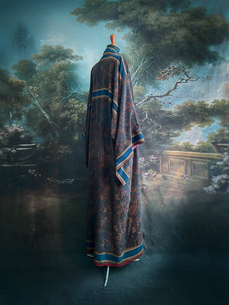 Full length 1920s inspired kimono robe with large patch pockets. Newly created from a blue, red and pumpkin vintage silk crepe. Fully lined in silk with French seams throughout. Bohemian styles sustainably created from antique and vintage textiles by the Pavilion Parade studio.