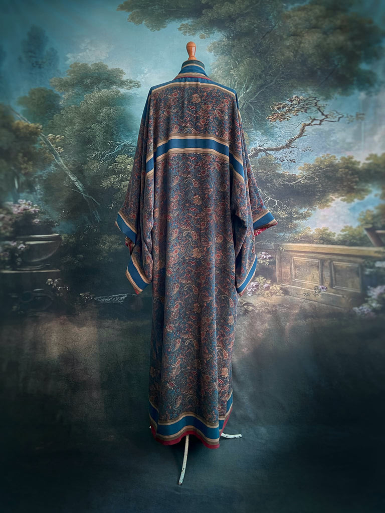 Full length 1920s inspired kimono robe with large patch pockets. Newly created from a blue, red and pumpkin vintage silk crepe. Fully lined in silk with French seams throughout. Bohemian styles sustainably created from antique and vintage textiles by the Pavilion Parade studio.