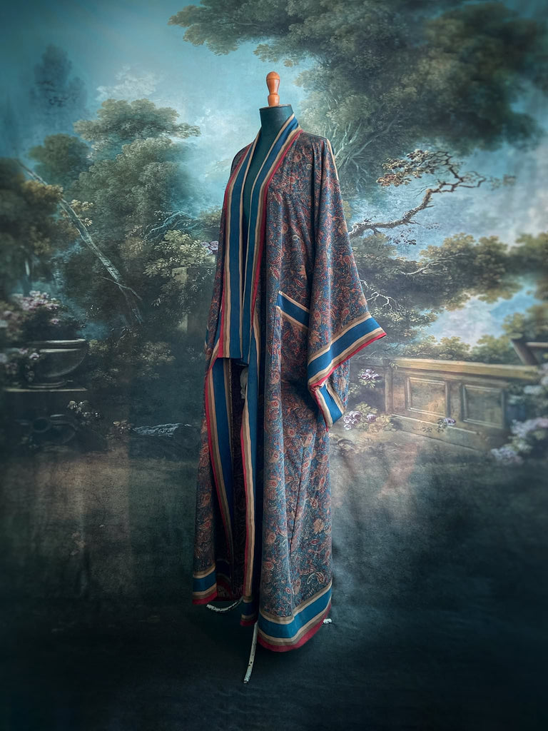 Full length 1920s inspired kimono robe with large patch pockets. Newly created from a blue, red and pumpkin vintage silk crepe. Fully lined in silk with French seams throughout. Bohemian styles sustainably created from antique and vintage textiles by the Pavilion Parade studio.