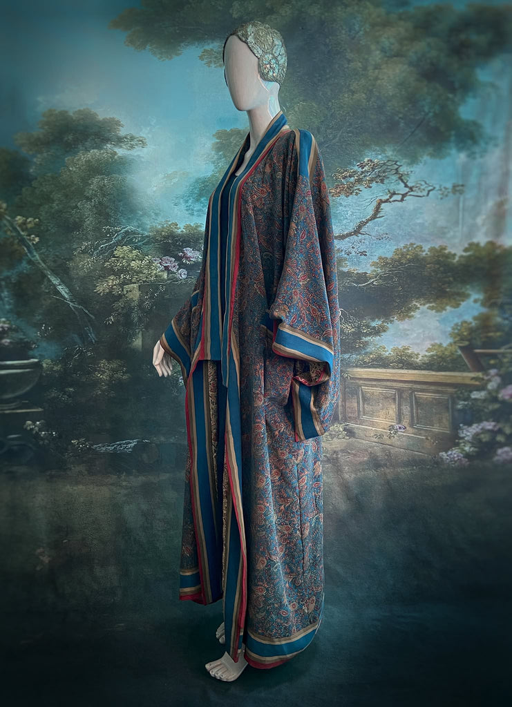 Full length 1920s inspired kimono robe with large patch pockets. Newly created from a blue, red and pumpkin vintage silk crepe. Fully lined in silk with French seams throughout. Bohemian styles sustainably created from antique and vintage textiles by the Pavilion Parade studio.
