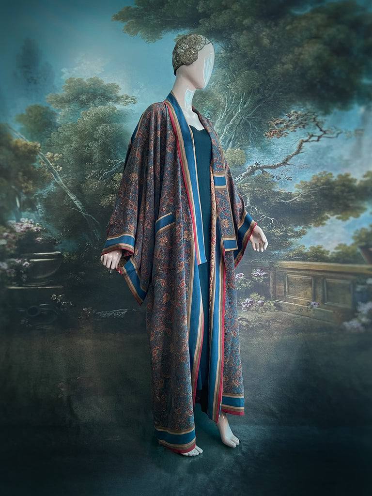 Full length 1920s inspired kimono robe with large patch pockets. Newly created from a blue, red and pumpkin vintage silk crepe. Fully lined in silk with French seams throughout. Bohemian styles sustainably created from antique and vintage textiles by the Pavilion Parade studio.