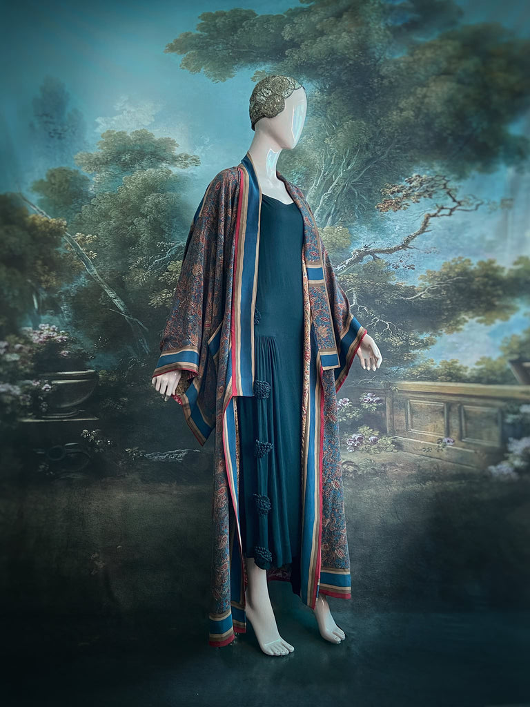 Full length 1920s inspired kimono robe with large patch pockets. Newly created from a blue, red and pumpkin vintage silk crepe. Fully lined in silk with French seams throughout. Bohemian styles sustainably created from antique and vintage textiles by the Pavilion Parade studio.