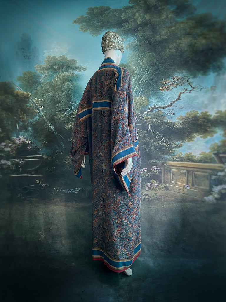 Full length 1920s inspired kimono robe with large patch pockets. Newly created from a blue, red and pumpkin vintage silk crepe. Fully lined in silk with French seams throughout. Bohemian styles sustainably created from antique and vintage textiles by the Pavilion Parade studio.