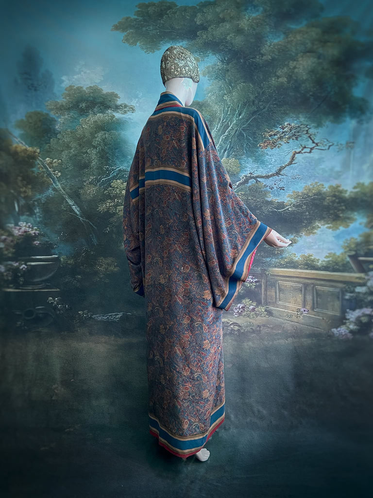 Full length 1920s inspired kimono robe with large patch pockets. Newly created from a blue, red and pumpkin vintage silk crepe. Fully lined in silk with French seams throughout. Bohemian styles sustainably created from antique and vintage textiles by the Pavilion Parade studio.
