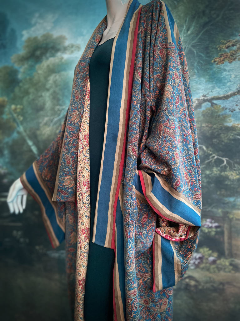 Full length 1920s inspired kimono robe with large patch pockets. Newly created from a blue, red and pumpkin vintage silk crepe. Fully lined in silk with French seams throughout. Bohemian styles sustainably created from antique and vintage textiles by the Pavilion Parade studio.