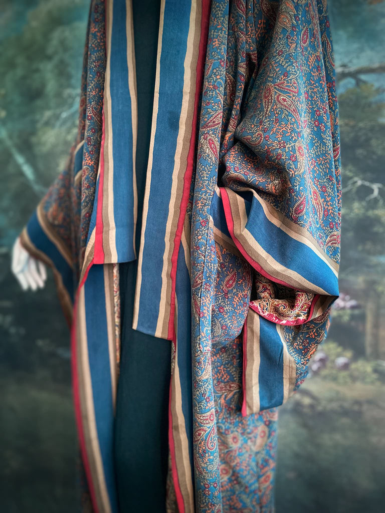 Full length 1920s inspired kimono robe with large patch pockets. Newly created from a blue, red and pumpkin vintage silk crepe. Fully lined in silk with French seams throughout. Bohemian styles sustainably created from antique and vintage textiles by the Pavilion Parade studio.