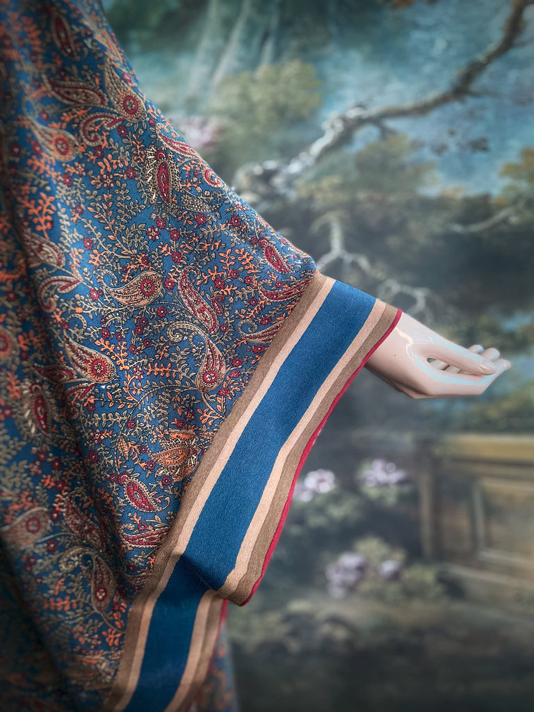 Full length 1920s inspired kimono robe with large patch pockets. Newly created from a blue, red and pumpkin vintage silk crepe. Fully lined in silk with French seams throughout. Bohemian styles sustainably created from antique and vintage textiles by the Pavilion Parade studio.