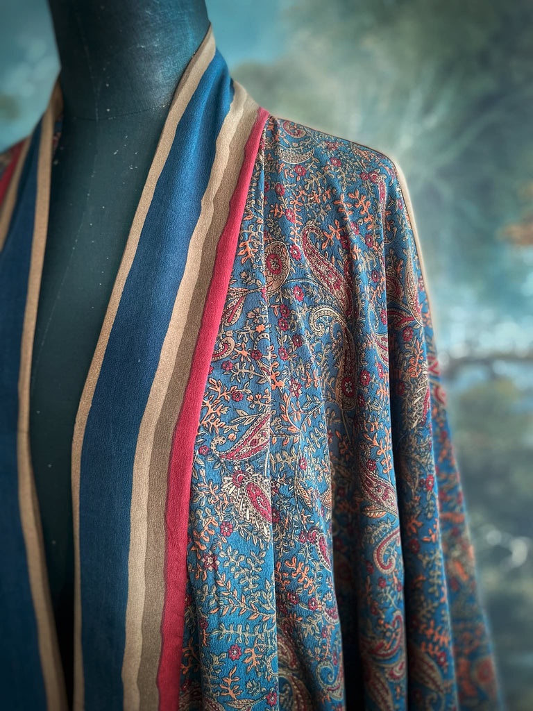 Full length 1920s inspired kimono robe with large patch pockets. Newly created from a blue, red and pumpkin vintage silk crepe. Fully lined in silk with French seams throughout. Bohemian styles sustainably created from antique and vintage textiles by the Pavilion Parade studio.