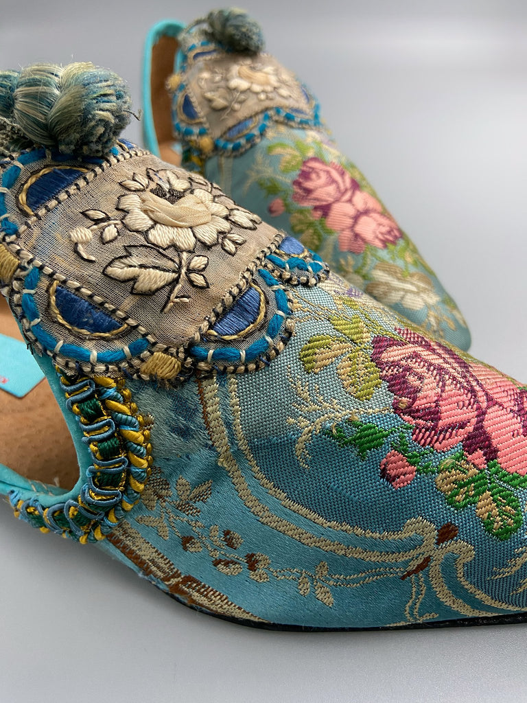 Faded sky blue silk pointed toe shoes with pink roses in the Georgian style. Embellished with silk embroidered appliqués and antique braids. Bohemian styles sustainably created from antique textiles by Pavilion Parade.