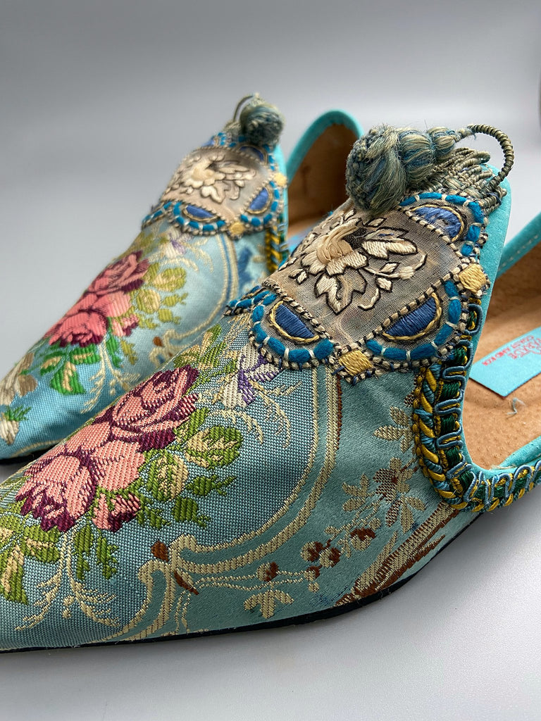 Faded sky blue silk pointed toe shoes with pink roses in the Georgian style. Embellished with silk embroidered appliqués and antique braids. Bohemian styles sustainably created from antique textiles by Pavilion Parade.