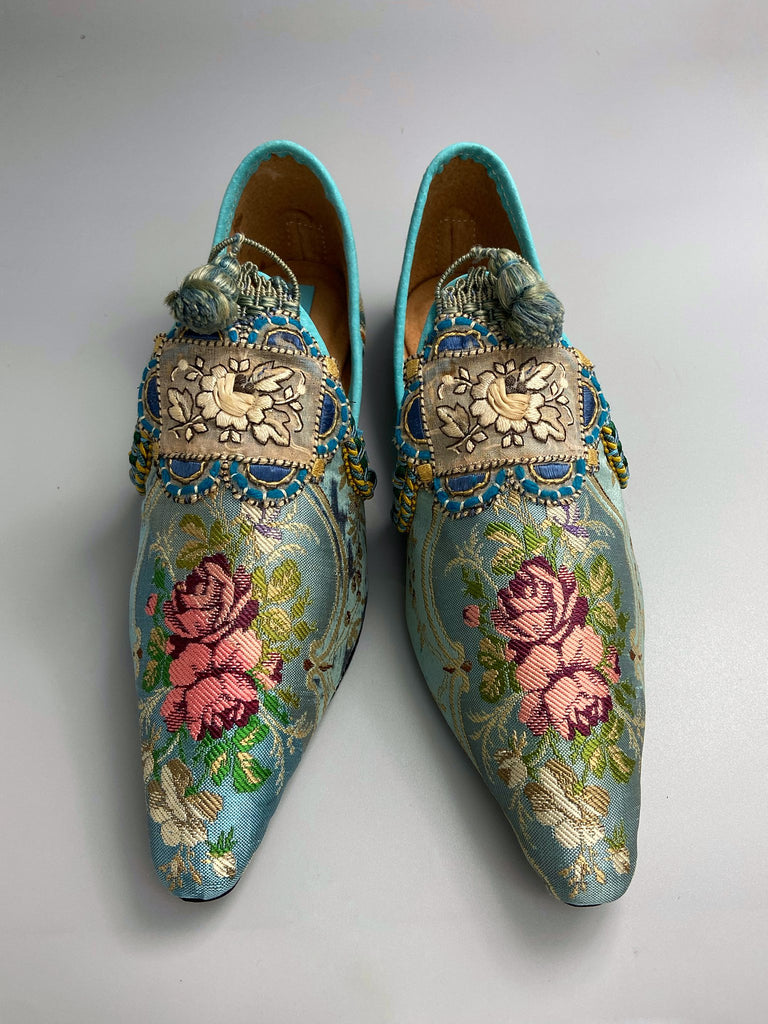 Faded sky blue silk pointed toe shoes with pink roses in the Georgian style. Embellished with silk embroidered appliqués and antique braids. Bohemian styles sustainably created from antique textiles by Pavilion Parade.