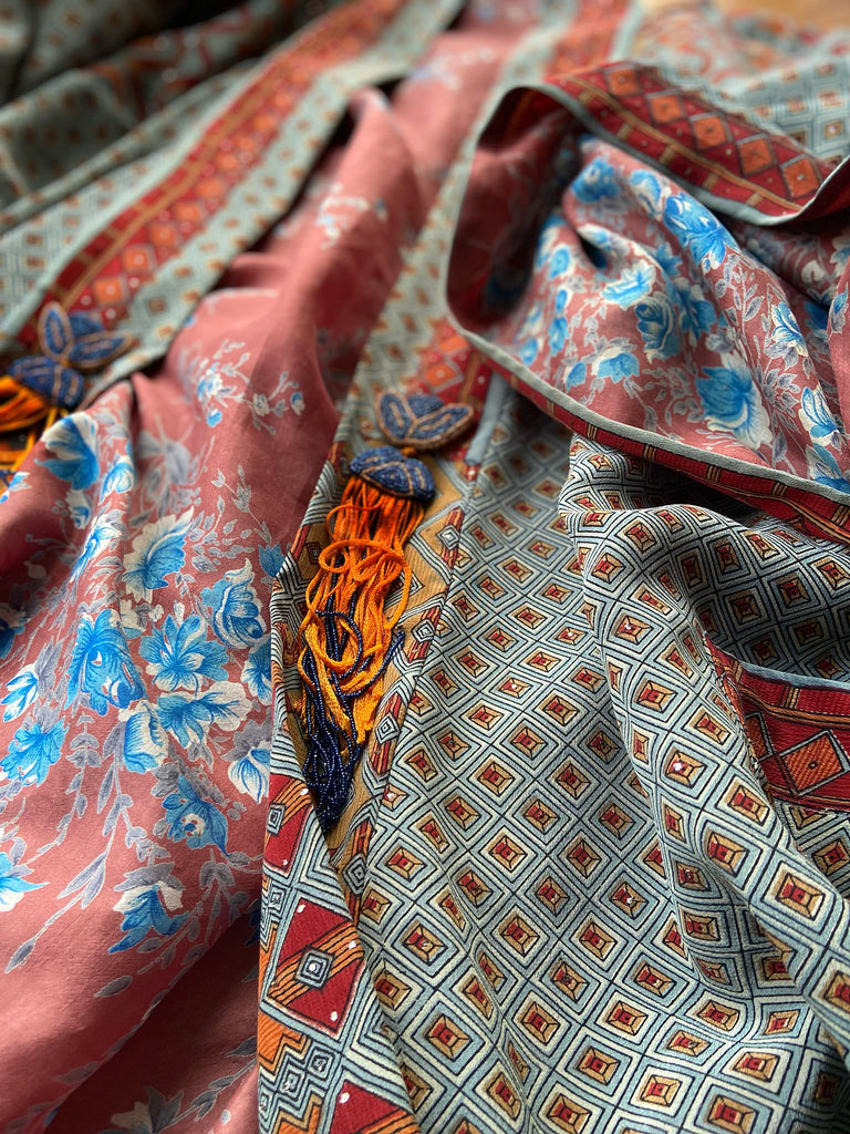 Full length 1920s inspired kimono robe with large patch pockets and antique Art Deco beaded tassels. Newly created from a dusty slate blue, rust and mustard vintage silk crepe with silver wire Mukesh work detail. Fully lined in silk with French seams throughout. Bohemian styles sustainably created from antique and vintage textiles by the Pavilion Parade studio.