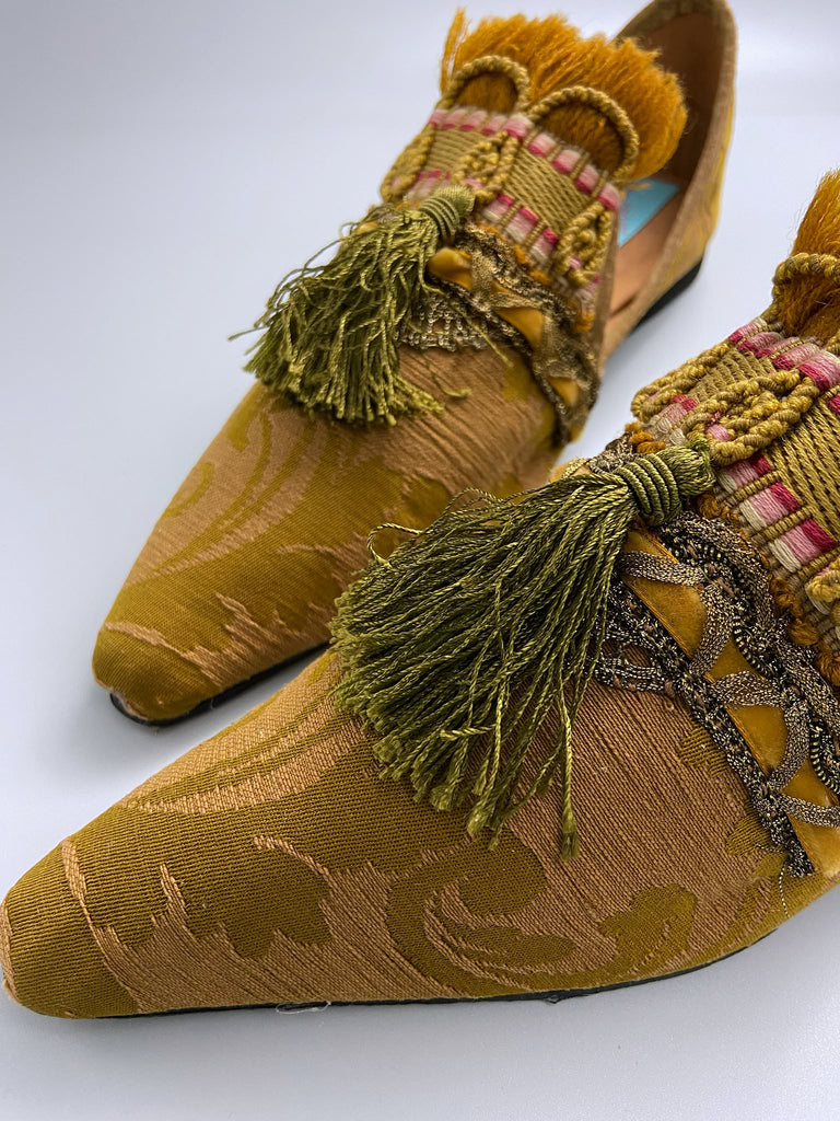 Bronze silk damask pointed toe shoes embellished with ochre fringing, metallic braids and olive green silk tassels. Bohemian style from the Pavilion Parade studio.