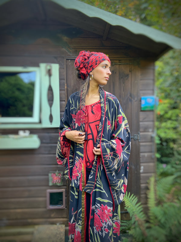 Full length 1920s inspired kimono robe with large patch pockets. Newly created from a scarlet and black 1930s style splashy floral vintage silk crepe. Fully lined in silk with French seams throughout. Bohemian styles sustainably created from antique and vintage textiles by the Pavilion Parade studio.