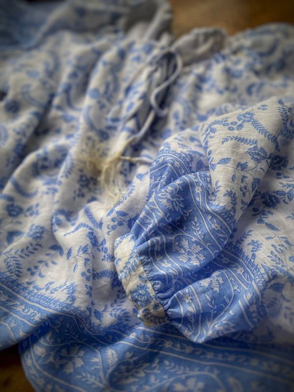 China blue and white cotton muslin block printed blouse with long full sleeves and adjustable drawstring neckline. Bohemian styles sustainably created from antique and vintage textiles by the Pavilion Parade studio. 