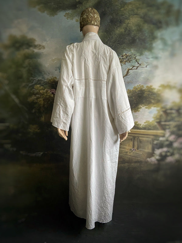 Full length kimono inspired robe with large patch pockets and wide sleeves. Created from an antique heavy French linen trousseau sheet with heirloom embroidery and drawn thread work. All French seamed with hand finished hems and collar. Bohemian styles sustainably created from antique and vintage textiles by the Pavilion Parade studio.
