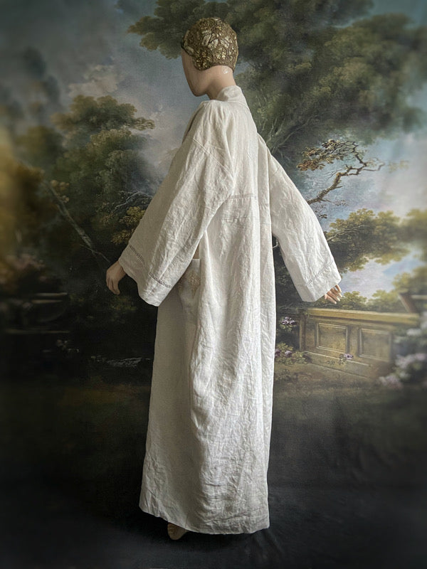Full length kimono inspired robe with large patch pockets and wide sleeves. Created from an antique heavy French linen trousseau sheet with heirloom embroidery and drawn thread work. All French seamed with hand finished hems and collar. Bohemian styles sustainably created from antique and vintage textiles by the Pavilion Parade studio.
