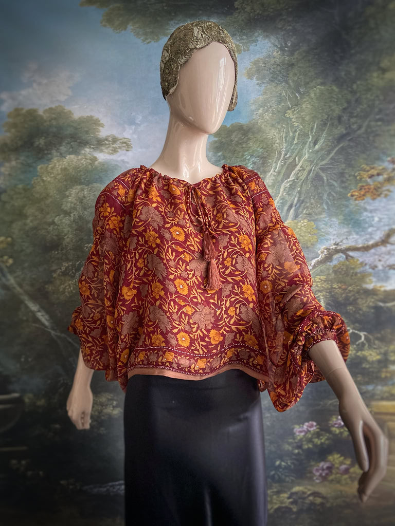 Cinnamon and saffron silk georgette blouse with long full sleeves and adjustable drawstring neckline. Bohemian styles sustainably created from antique and vintage textiles by the Pavilion Parade studio. 