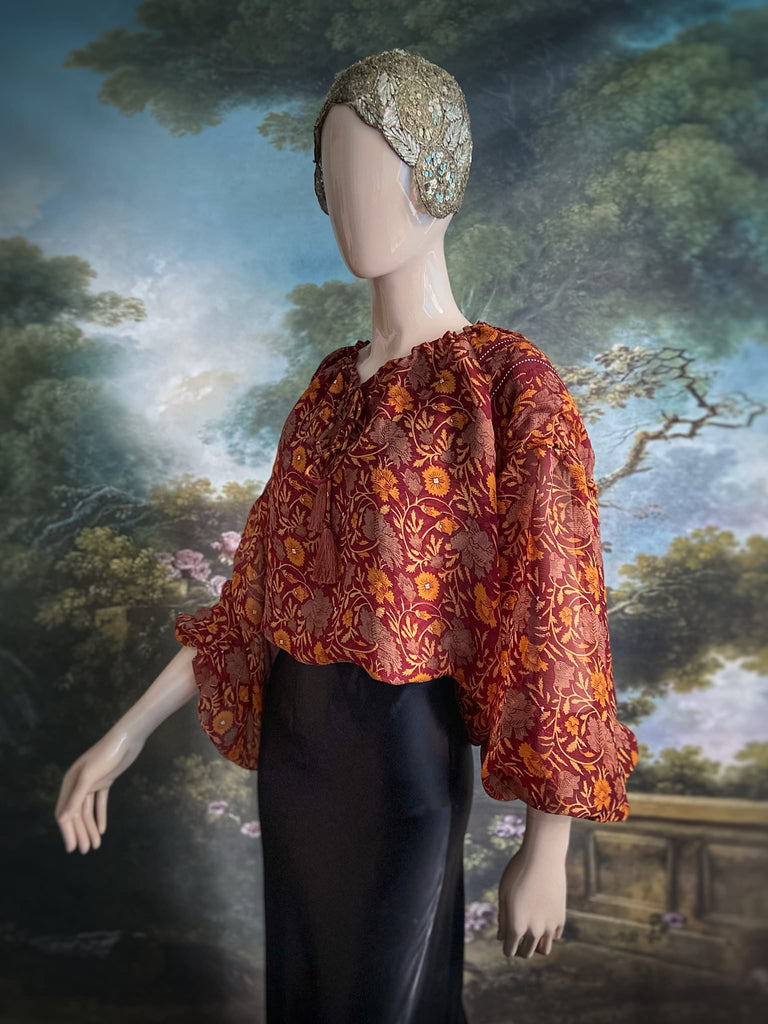 Cinnamon and saffron silk georgette blouse with long full sleeves and adjustable drawstring neckline. Bohemian styles sustainably created from antique and vintage textiles by the Pavilion Parade studio. 