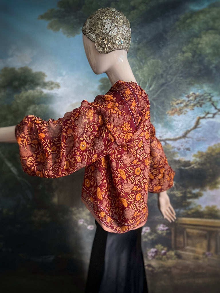 Cinnamon and saffron silk georgette blouse with long full sleeves and adjustable drawstring neckline. Bohemian styles sustainably created from antique and vintage textiles by the Pavilion Parade studio. 