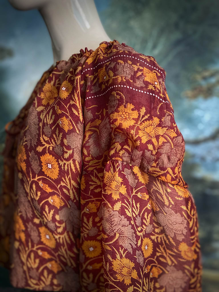 Cinnamon and saffron silk georgette blouse with long full sleeves and adjustable drawstring neckline. Bohemian styles sustainably created from antique and vintage textiles by the Pavilion Parade studio. 