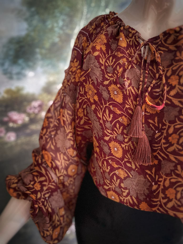 Cinnamon and saffron silk georgette blouse with long full sleeves and adjustable drawstring neckline. Bohemian styles sustainably created from antique and vintage textiles by the Pavilion Parade studio. 