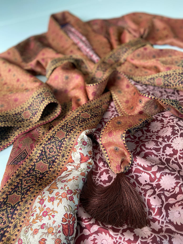 Cinnamon, pumpkin, and soot silk and wool robe with wide sleeves, tassel sash, and deep pockets. Unique bohemian styles sustainably created from vintage textiles by the Pavilion Parade studio.