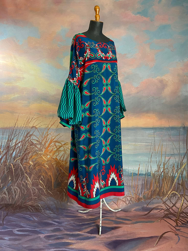 Silk crepe shift dress with pockets and volume long sleeves gathered in to fitted cuffs. Bold grphic print in shades of cobalt blue, teal and scarlet.  Unique garments sustainably created from vintage textiles by the Pavilion Parade studio.