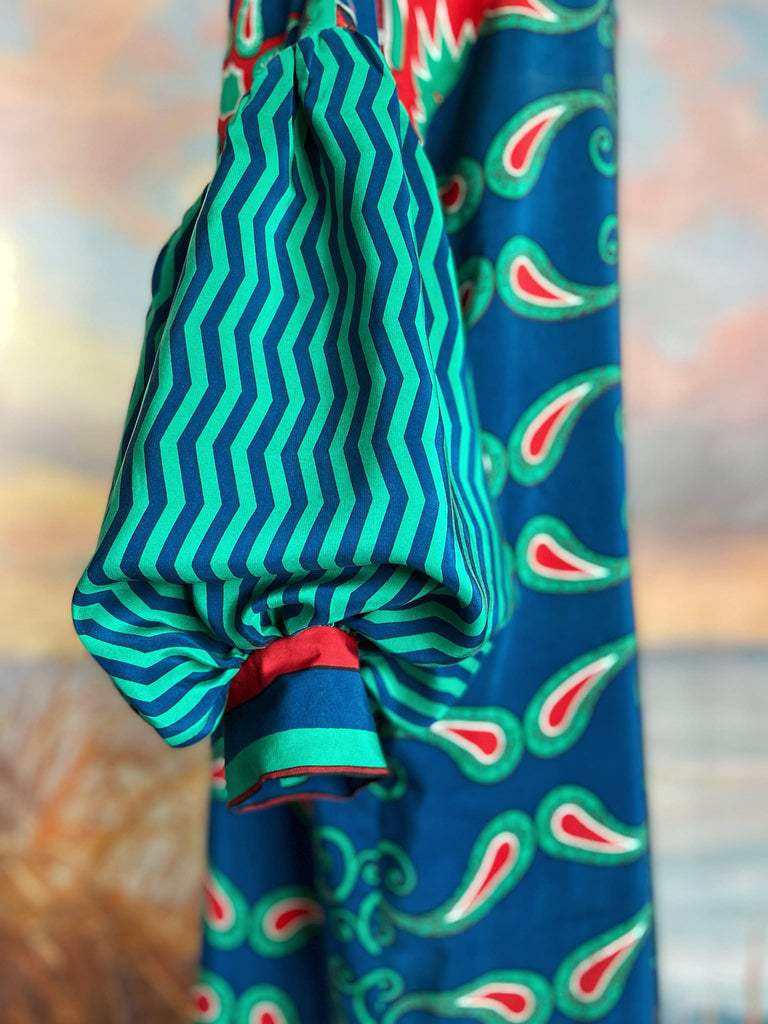 Silk crepe shift dress with pockets and volume long sleeves gathered in to fitted cuffs. Bold grphic print in shades of cobalt blue, teal and scarlet.  Unique garments sustainably created from vintage textiles by the Pavilion Parade studio.